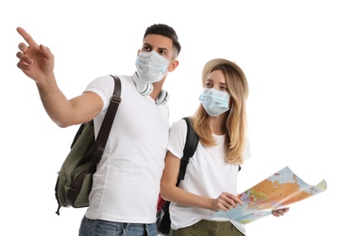 Photo of Couple in face masks with map on white background. Summer travel