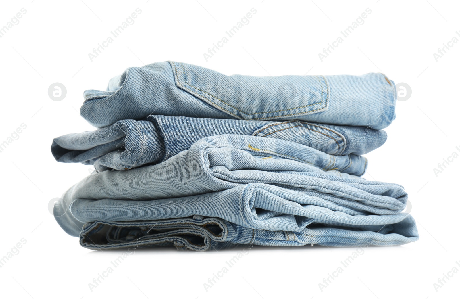 Photo of Stack of folded jeans isolated on white