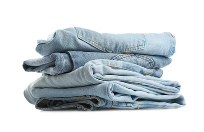Stack of folded jeans isolated on white