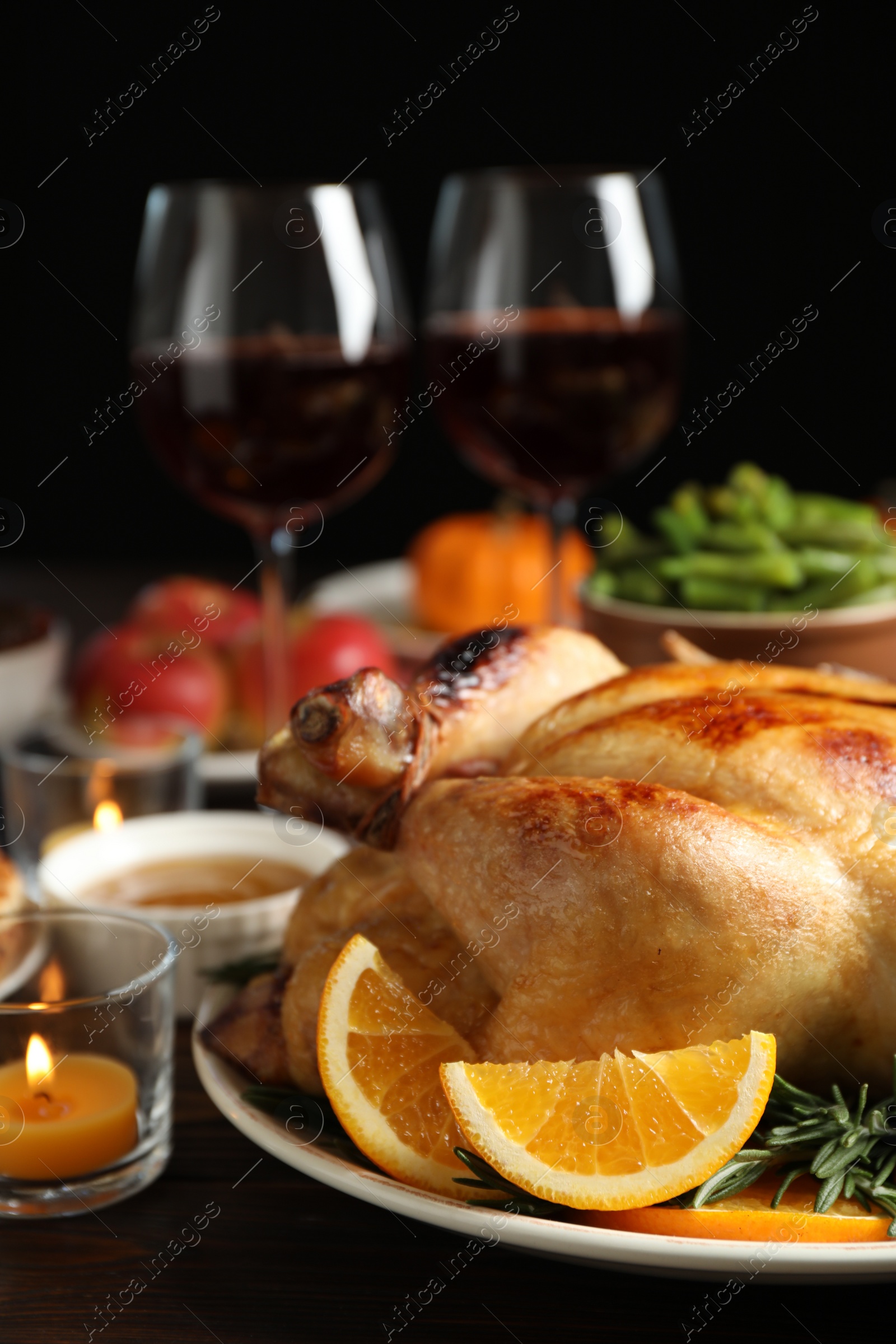 Photo of Traditional Thanksgiving day feast with delicious cooked turkey and other seasonal dishes served on table, closeup