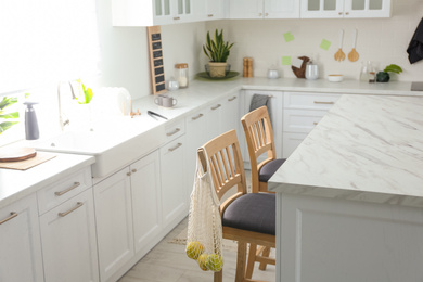 Photo of Modern kitchen interior with stylish marble table