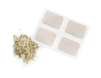 Photo of Mustard powder and plaster on white background, top view