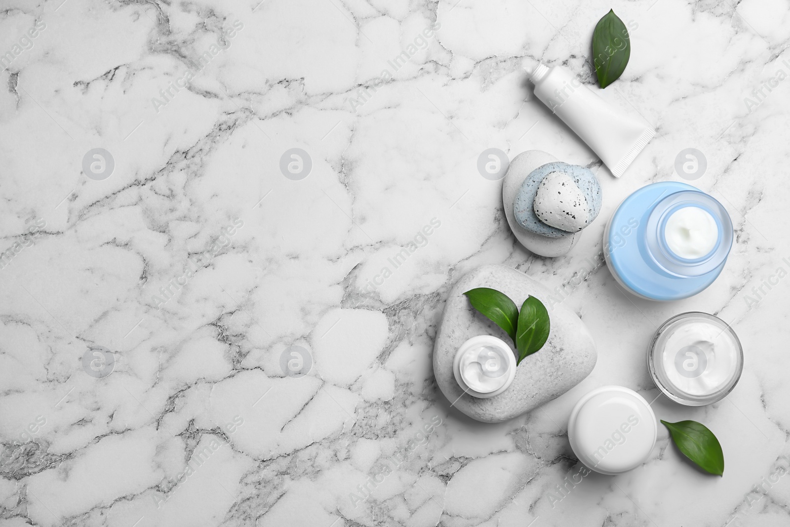 Photo of Composition with body cream in jars on light background