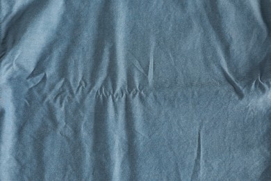 Crumpled light blue fabric as background, top view