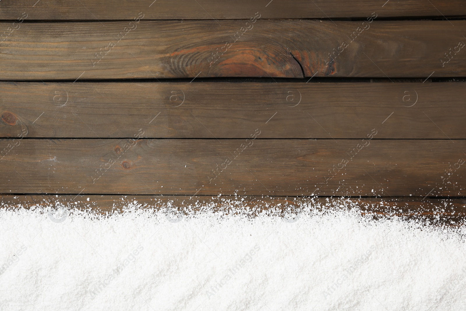 Photo of Artificial snow on wooden background, top view with space for text. Christmas decor