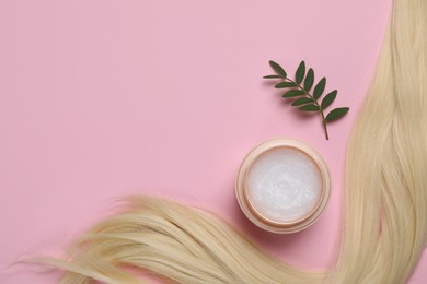 Photo of Lock of healthy blond hair, green twig and cosmetic product on pink background, flat lay. Space for text