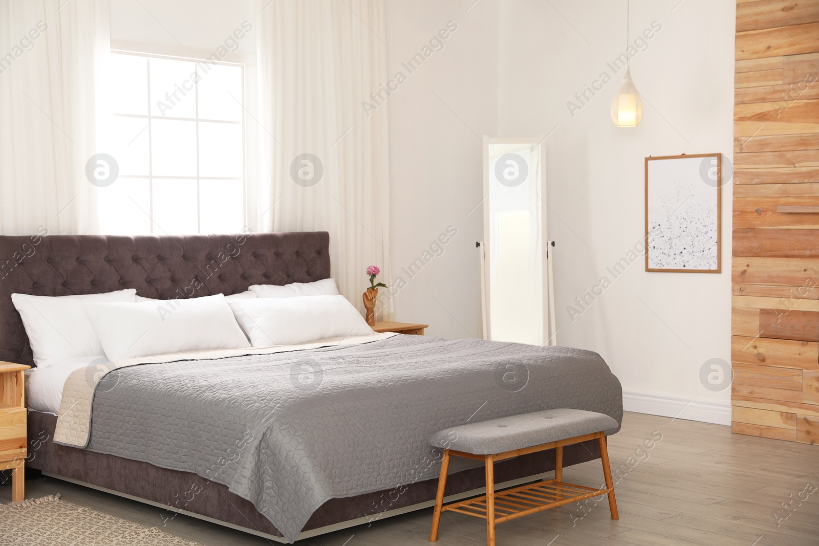 Photo of Modern comfortable bed in room. Interior design