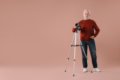 Senior astronomer with telescope on brown background. Space for text