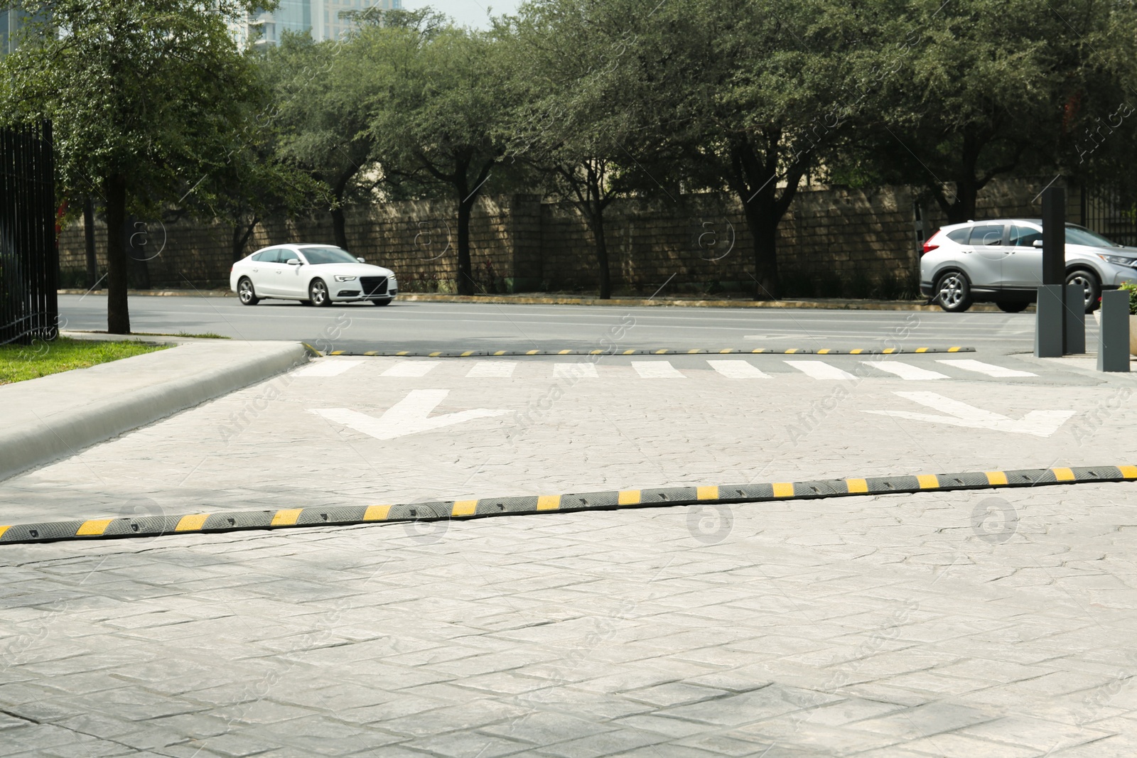 Photo of City street with striped plastic speed bump