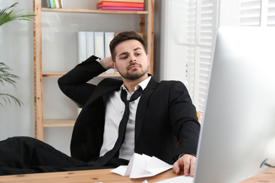 Photo of Lazy employee resting at table in office