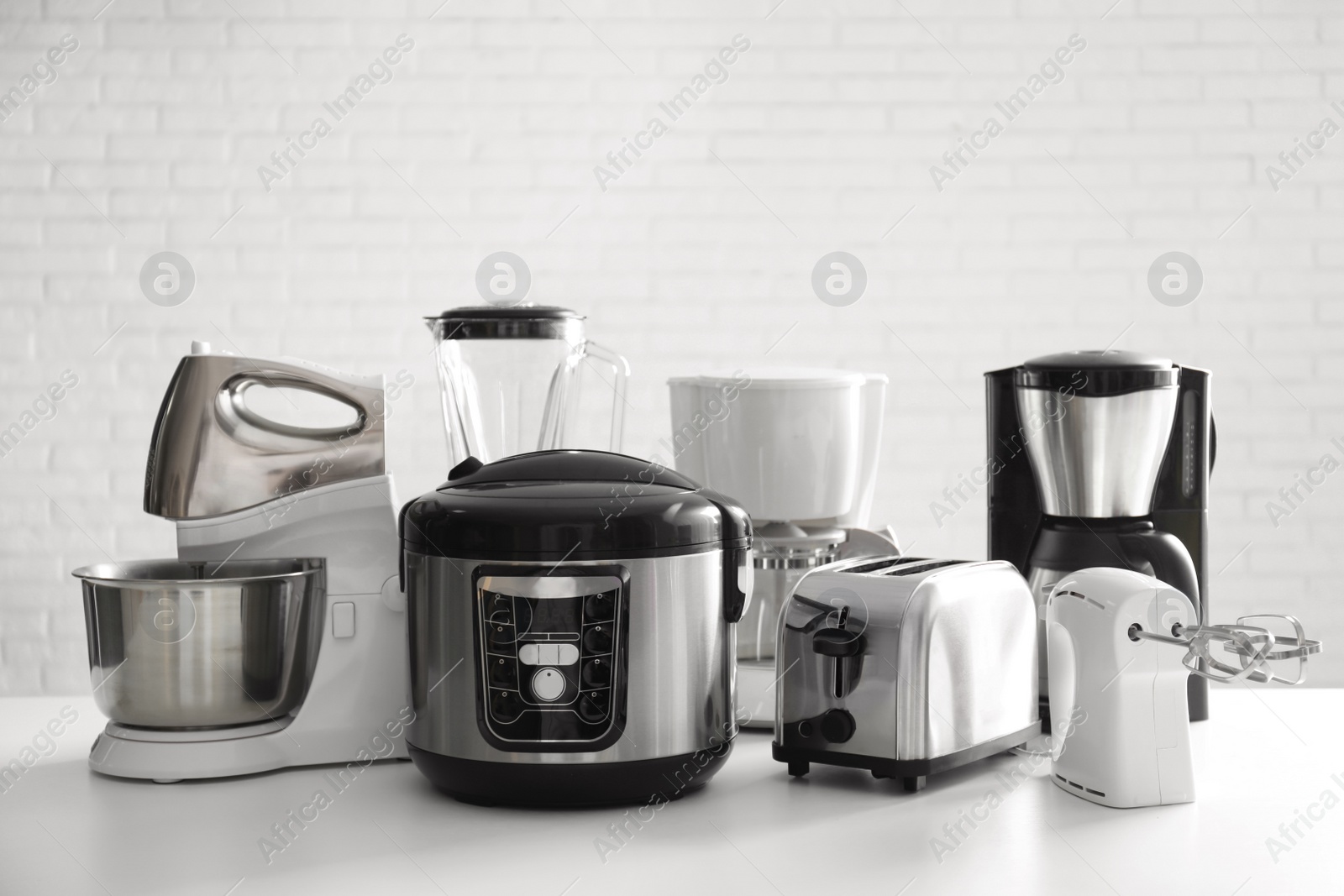 Photo of Set of modern home appliances on white table