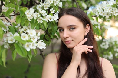 Photo of Beautiful woman near blossoming tree on spring day