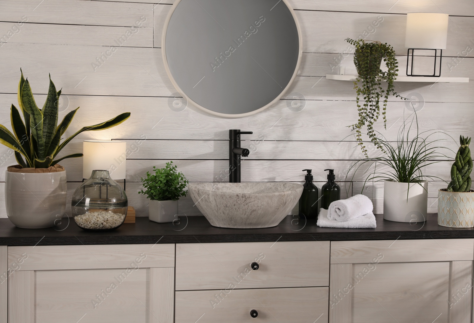 Photo of Stylish bathroom interior with vessel sink and beautiful plants