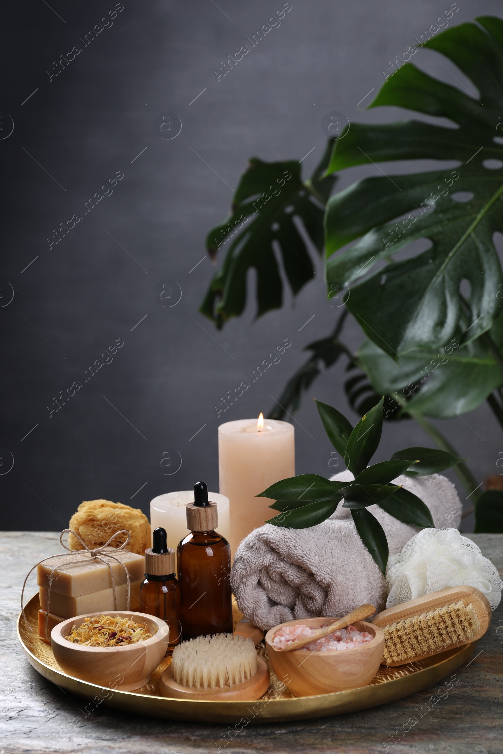 Photo of Spa composition. Brushes, bottles and sea salt on table