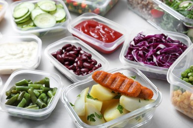 Photo of Set of containers with fresh food on white table