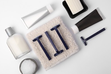 Different men's shaving accessories on white background, flat lay