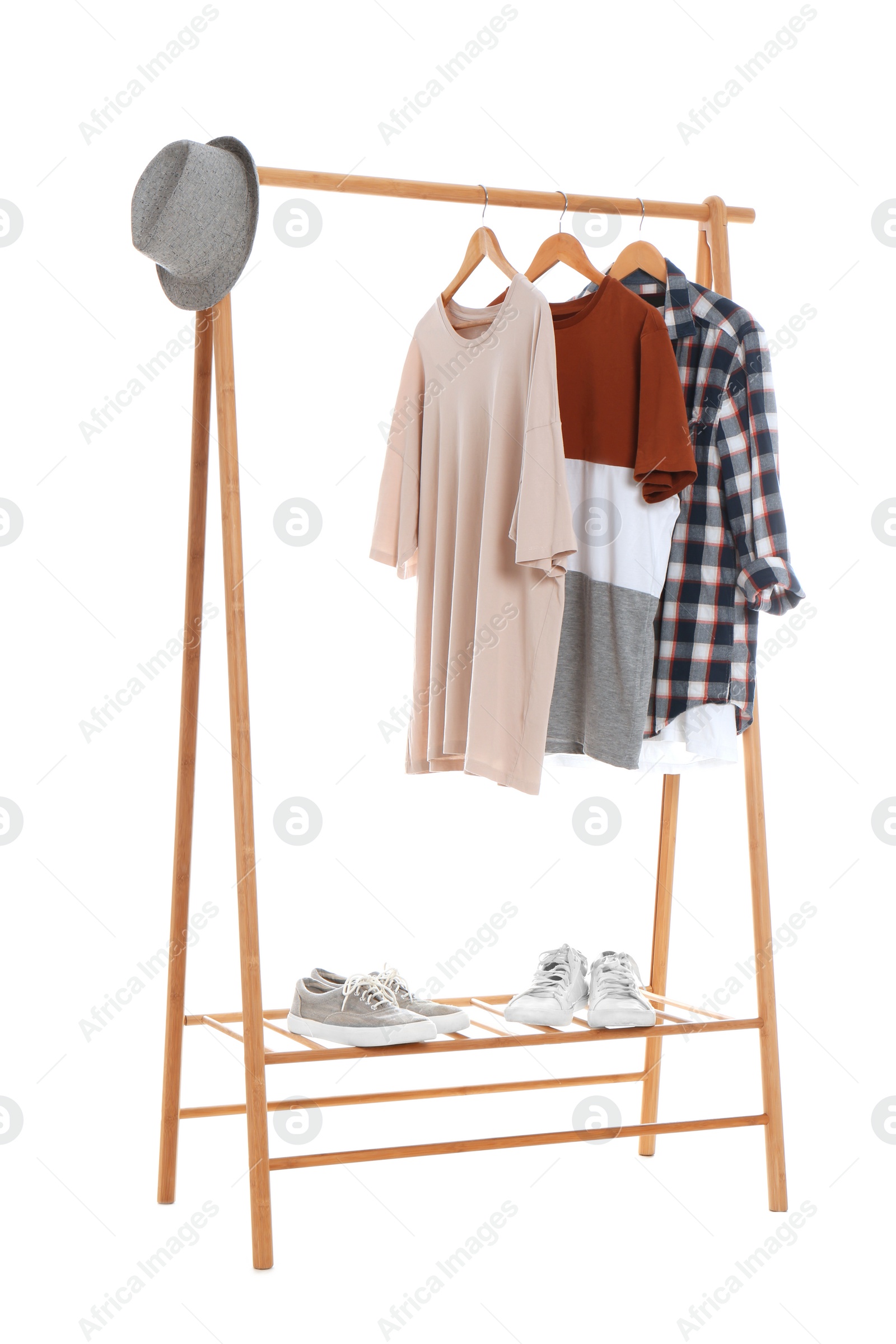 Photo of New wardrobe rack with stylish man's clothes and shoes on white background