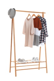 Photo of New wardrobe rack with stylish man's clothes and shoes on white background