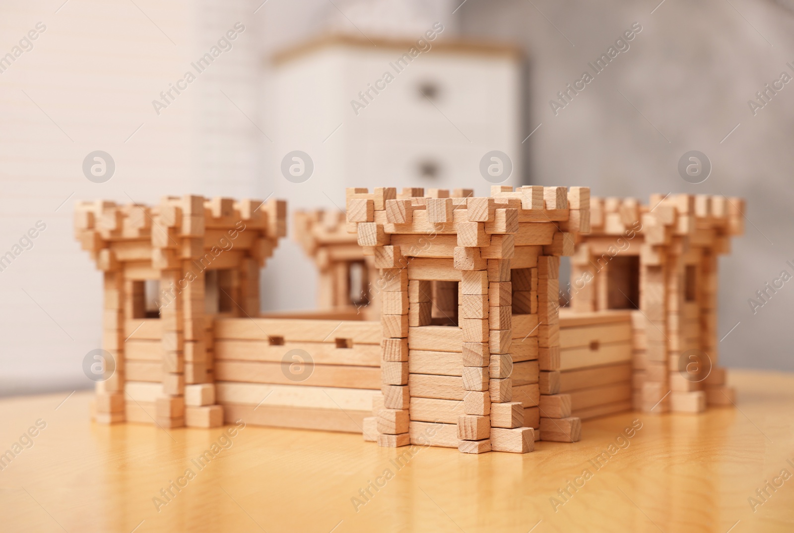 Photo of Wooden fortress on table indoors. Children's toy