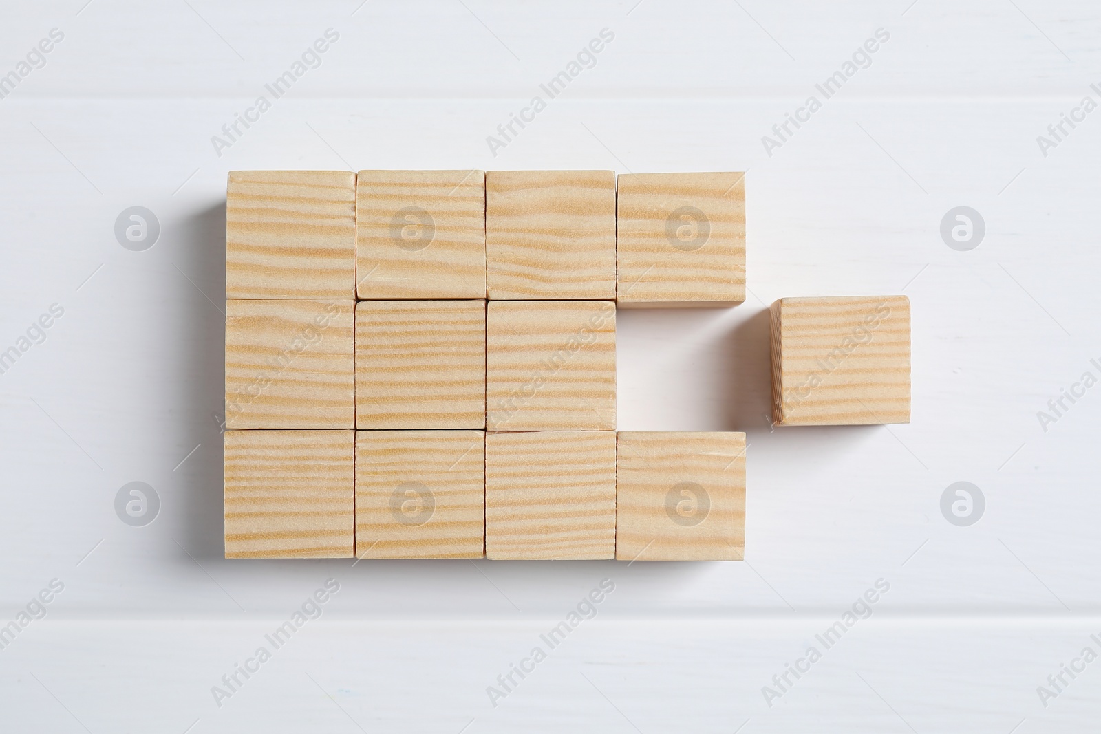 Photo of Blank cubes on white wooden table, flat lay