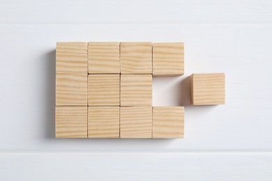 Photo of Blank cubes on white wooden table, flat lay