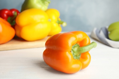 Photo of Fresh ripe bell peppers on wooden table