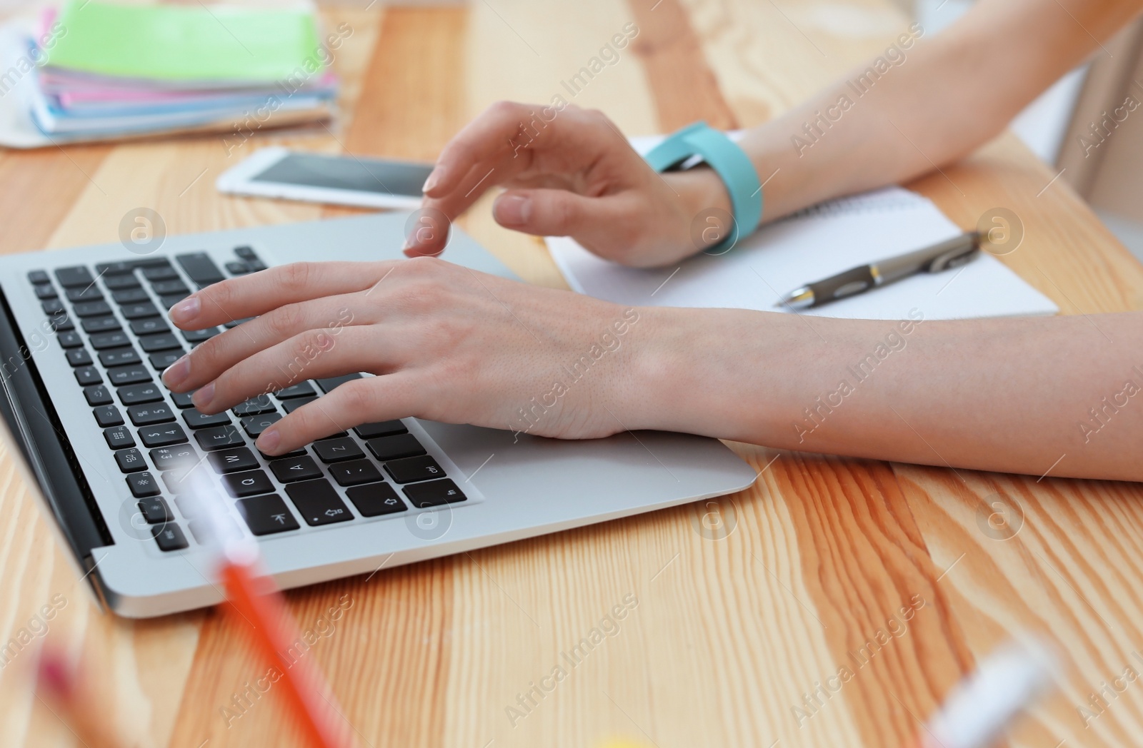 Photo of Young woman working with laptop at desk. Home office