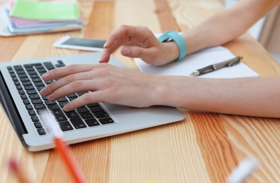 Young woman working with laptop at desk. Home office