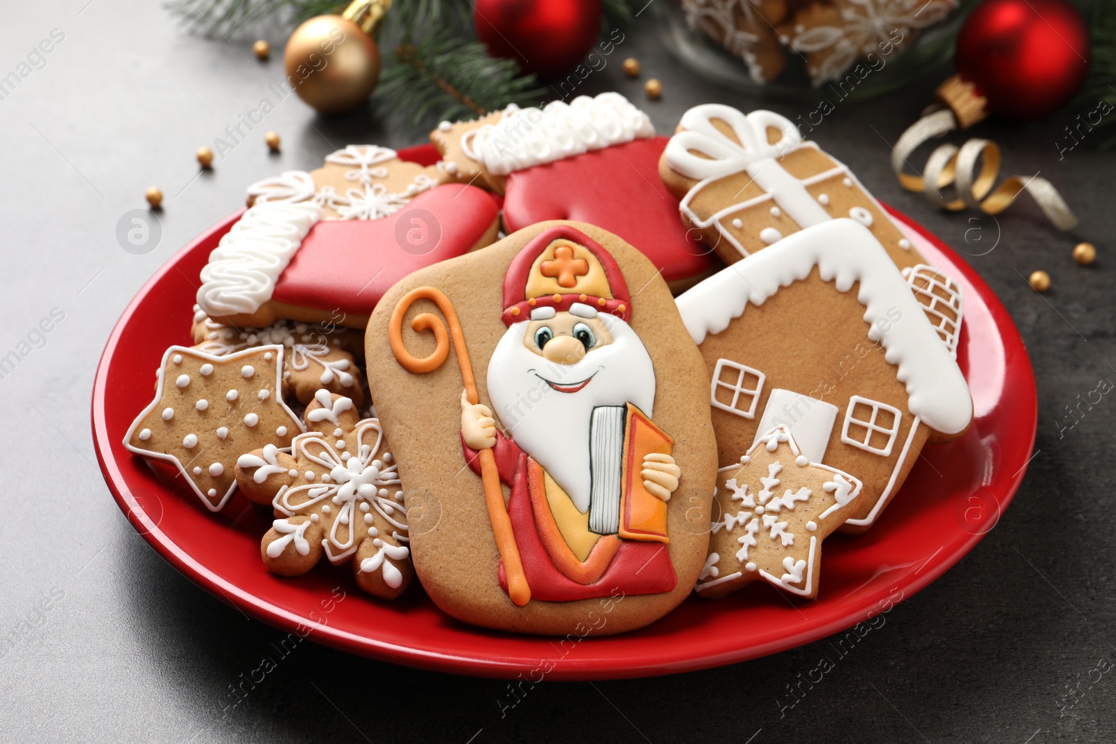 Photo of Tasty gingerbread cookies on grey table, closeup. St. Nicholas Day celebration