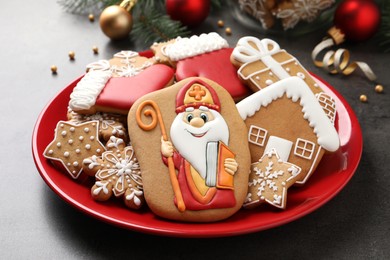 Tasty gingerbread cookies on grey table, closeup. St. Nicholas Day celebration