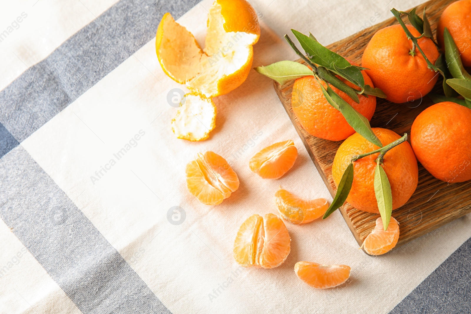 Photo of Flat lay composition with ripe tangerines on cloth. Space for text