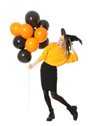 Photo of Beautiful woman wearing witch costume with balloons for Halloween party on white background