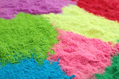 Colorful powder dyes as background, closeup. Holi festival