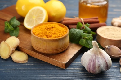 Photo of Different fresh products on blue wooden table, closeup. Natural antibiotics