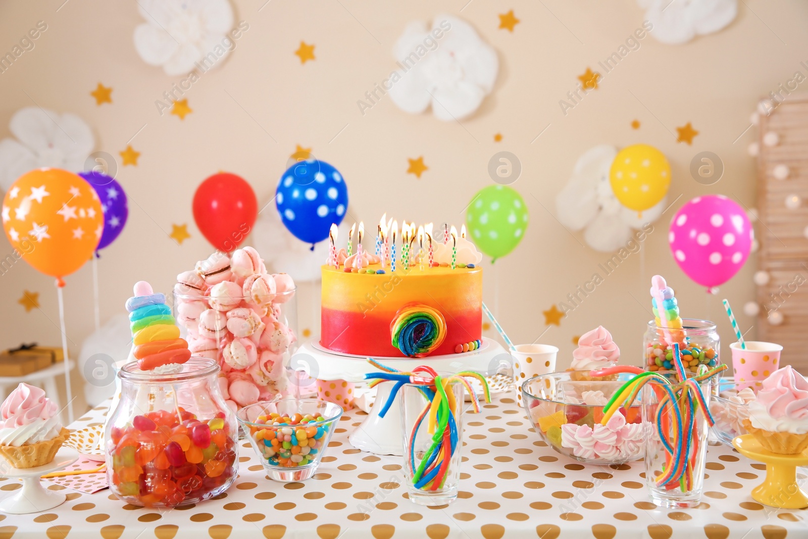 Photo of Table with birthday cake and delicious treats indoors