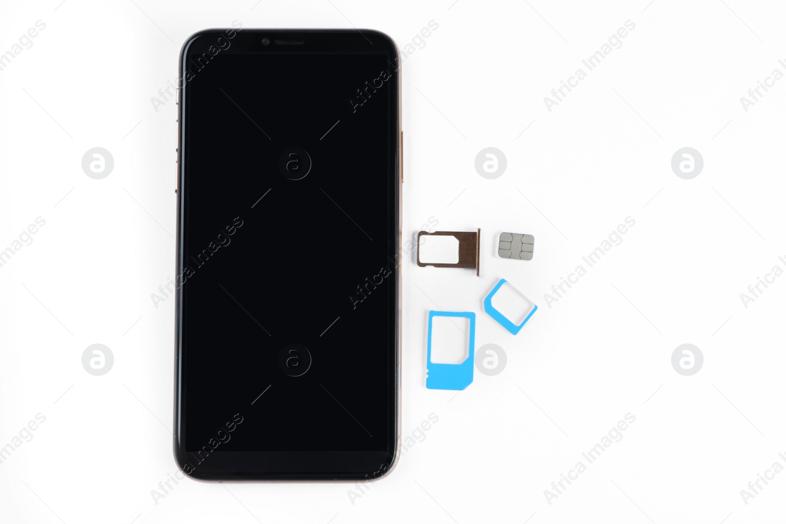 Photo of SIM cards and mobile phone on white table, top view