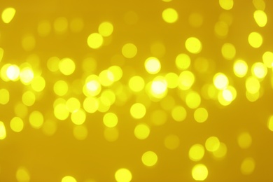 Photo of Blurred view of shiny gold lights. Bokeh effect