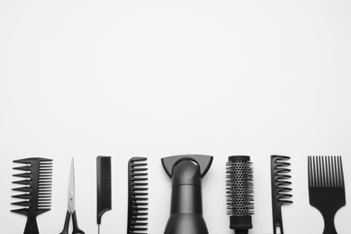 Photo of Flat lay composition with modern hair dryer on white background, space for text