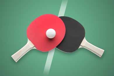 Image of Paddles and ball on green ping pong table, top view
