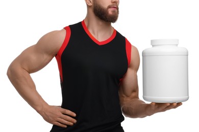 Young man with muscular body holding jar of protein powder on white background, closeup