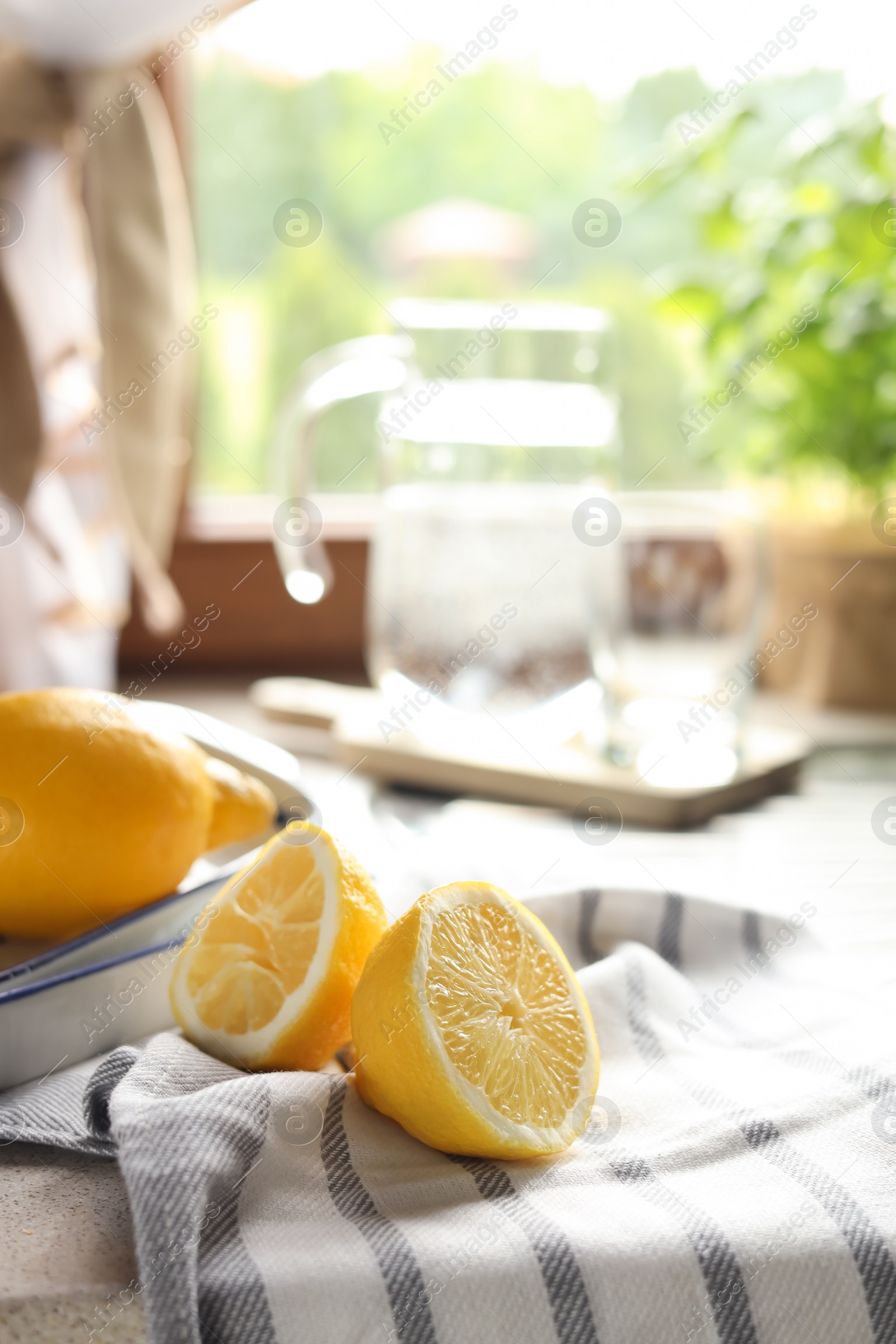 Photo of Fresh ripe lemons on countertop in kitchen, space for text