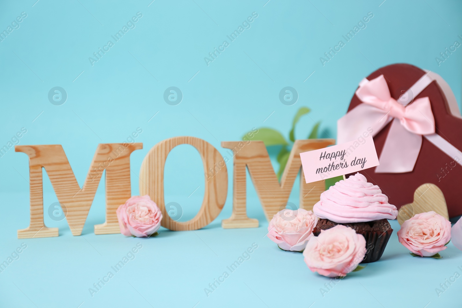 Photo of Festive surprise with tasty treat for Mother's Day on color background