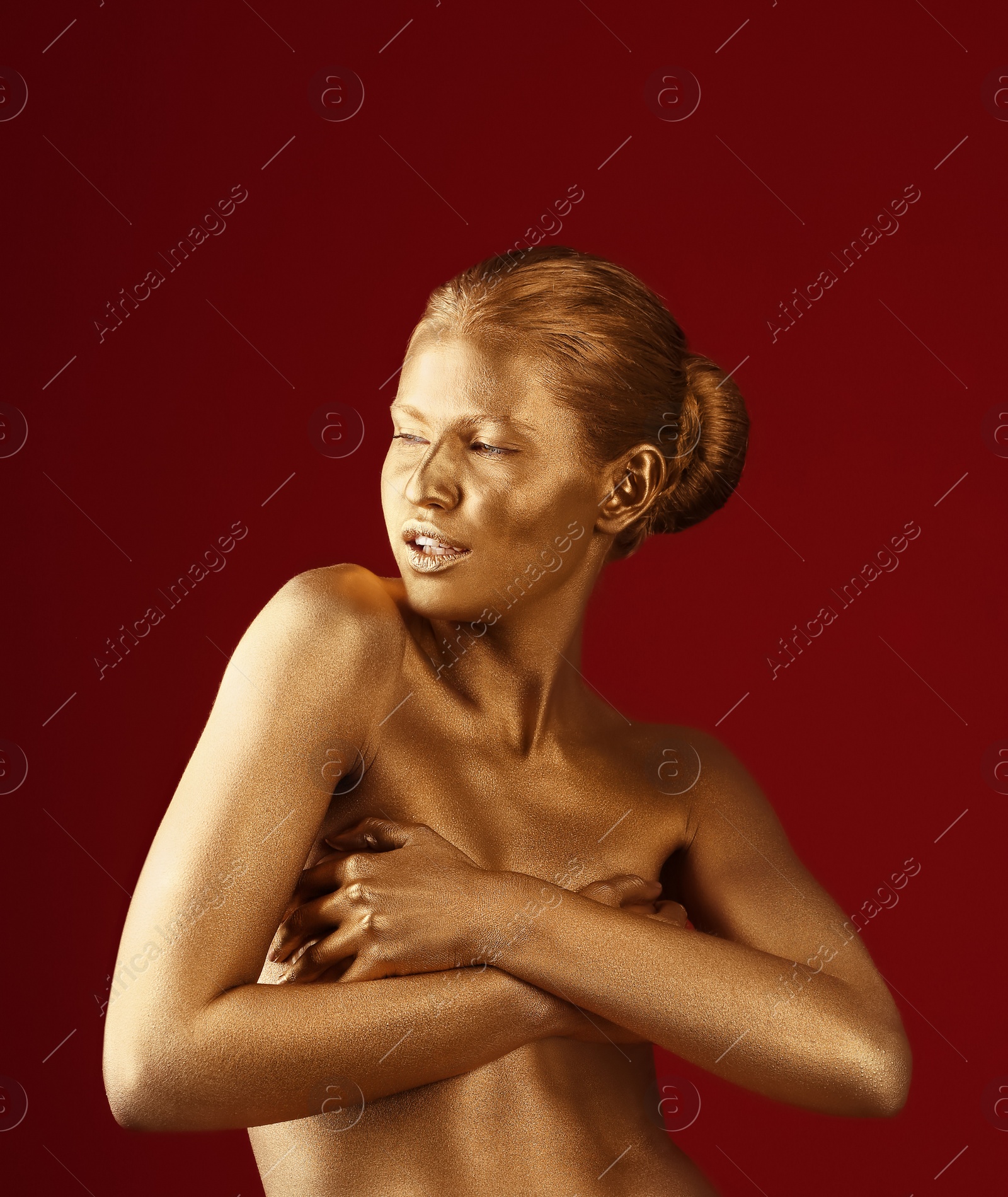 Photo of Portrait of beautiful lady with gold paint on skin against color background