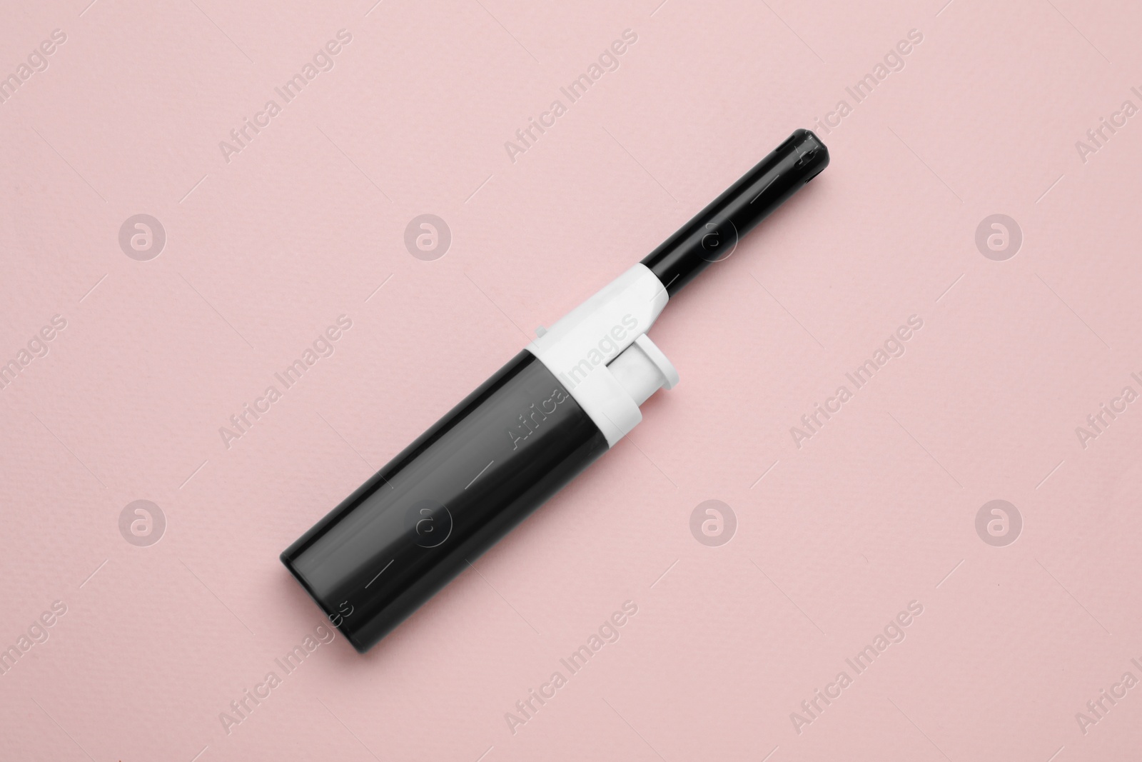 Photo of One gas lighter on beige background, top view