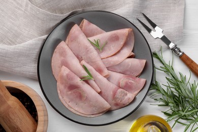 Photo of Tasty ham with rosemary served on white wooden table, flat lay