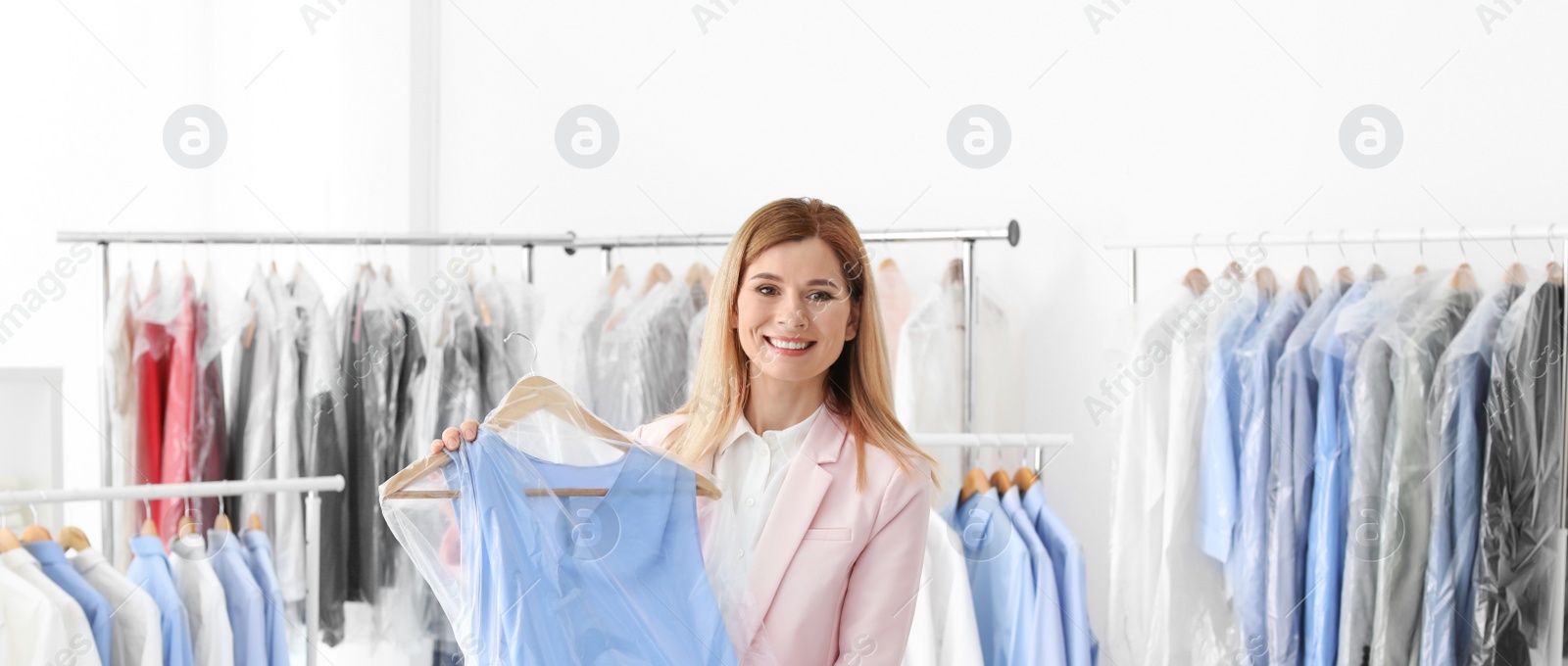Image of Woman holding hanger with dress in plastic bag, banner design. Dry-cleaning service