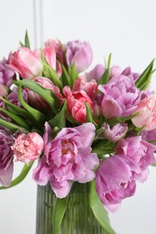 Beautiful bouquet of colorful tulip flowers in vase on white background