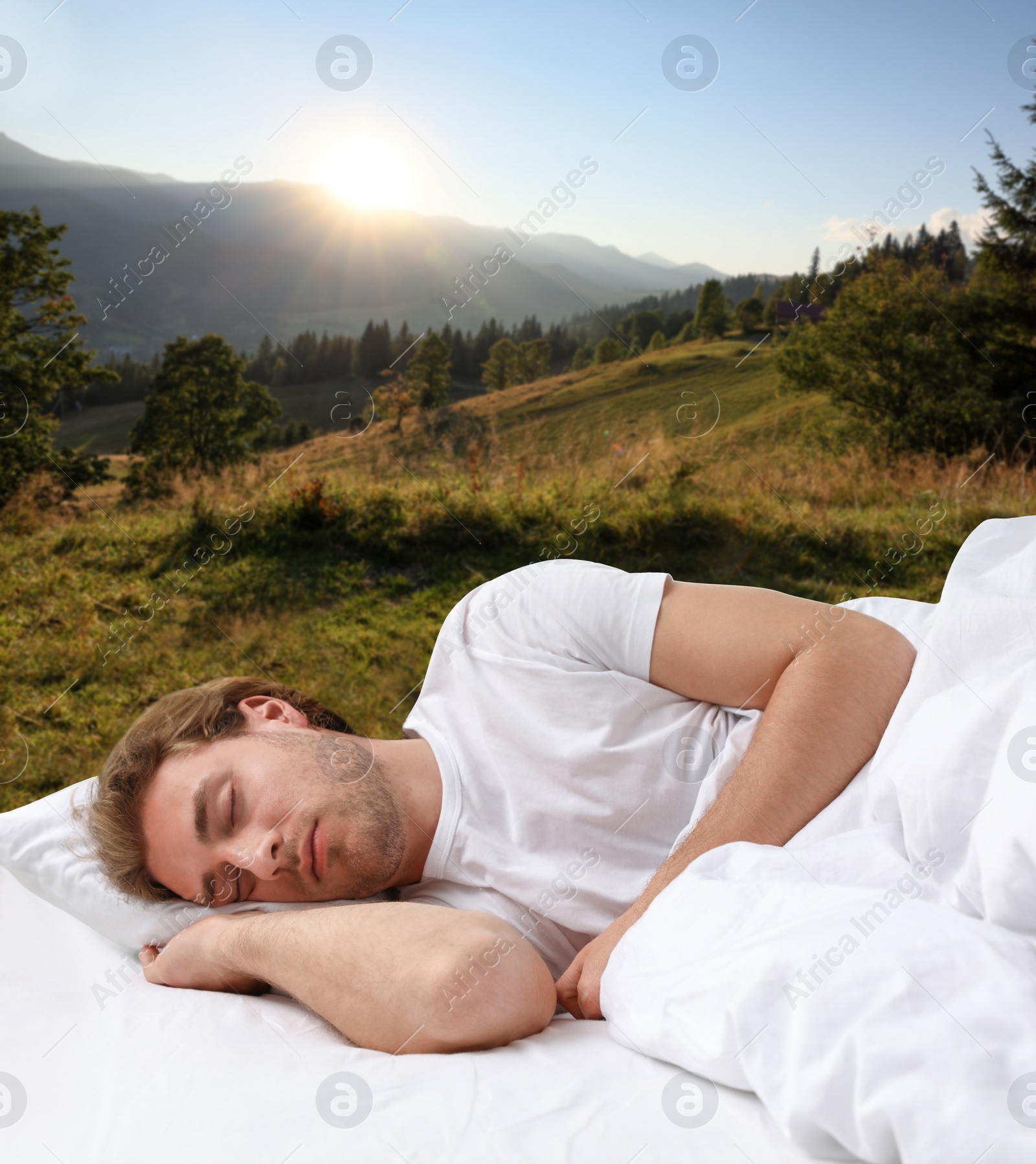 Image of Man sleeping in bed and beautiful view of mountain landscape on background. Sleep well - stay healthy