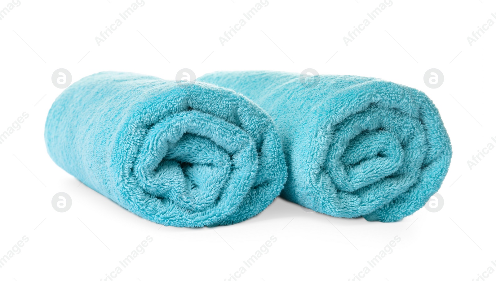 Photo of Rolled clean turquoise towels on white background