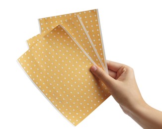 Photo of Woman holding pepper plasters on white background, closeup